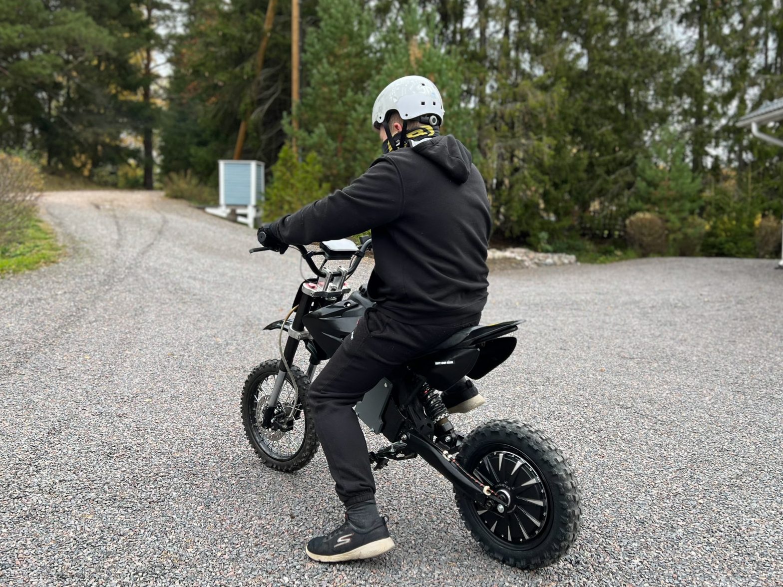 Boy sitting on an electric pit bike